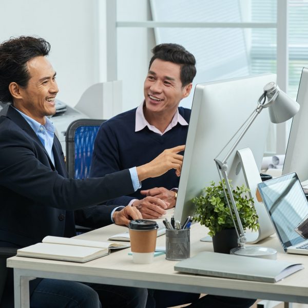 Cheerful Asian businessmen working in office Cheerful Asian businessmen working in office